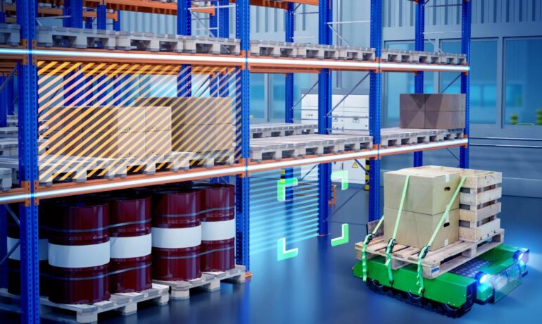 An autonomous robot transports a pallet loaded with boxes to storage on the bottom shelves of a warehouse.